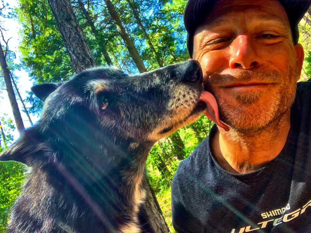 Dan Gitomer with his dog outdoors in Flagstaff